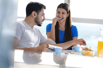 Young Couple Eating Breakfast At Home On Sunday