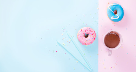 Two sweet doughnuts with cacao drink on blue and pink background banner with copy space