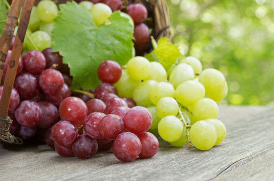 Fresh Red and Green Grapes on a Rustic Wooden Table