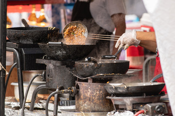 Oriental chicken food made to order at outdoor festival.