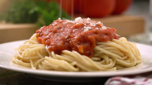 Italian spaghetti dinner with marinara / tomato sauce, parmesan cheese, and fresh vegetables. 