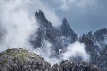 Mountain panorama in the Dolomite Alps, Italy. Mountain ridge in the clouds. Beautiful landscape at the summer time