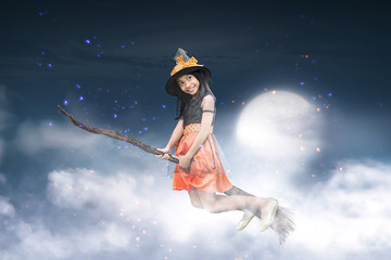 Obraz premium Happy asian witch girl flying on broomstick
