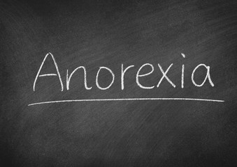Fototapeta premium Anorexia concept word on a blackboard background