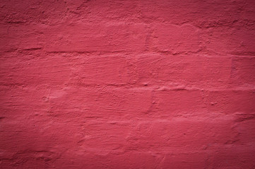 wall of brick painted red background. texture, vignette.