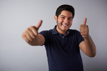 Smiling hispanic man with thumbs up