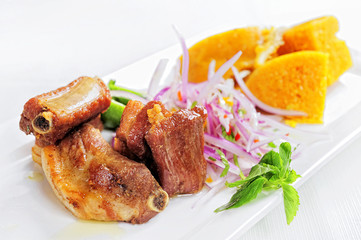 Traditional Peruvian Meal Called Chicharron de Panceta de Cerdo Served in a Restaurant.