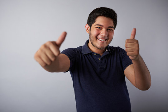 Smiling Hispanic Man With Thumbs Up