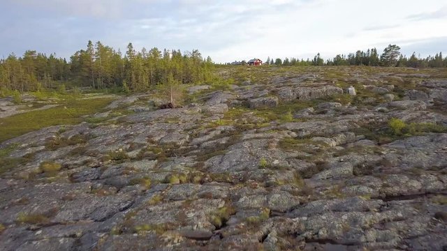 ARIEAL: Glight over ground to small village with lighthouse on island
