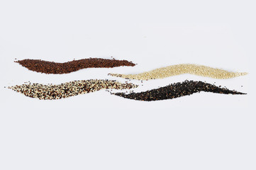 Black, red and white quinoa grains isolated on white background. Healthy food.