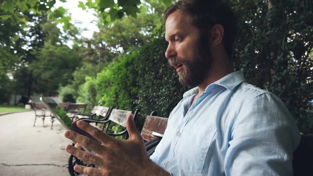 Angy young man say Fuck on tablet ,loosing concept