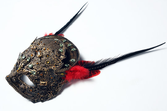 Golden mask with precious stones and feathers