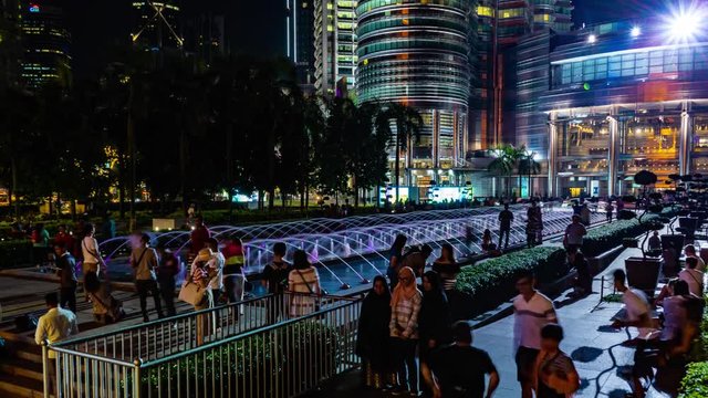 KUALA LUMPUR, MALAYSIA - May 15, 2018: Fountain at night with peoples near Petronas twin tower 4K