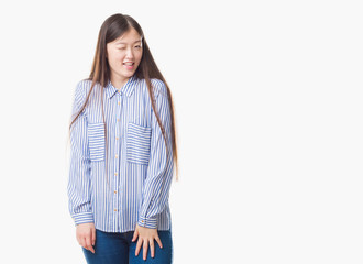 Young Chinese woman over isolated background winking looking at the camera with sexy expression, cheerful and happy face.
