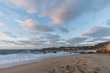 Fototapeta na wymiar sunrise over the beach with waves crashing