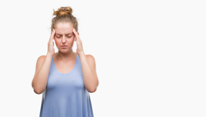 Fototapeta na wymiar Young blonde woman with hand on head for pain in head because stress. Suffering migraine.