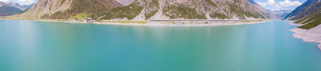 Drone aerial view of the Lake Livigno an alpine artificial lake. Italian Alps. Italy