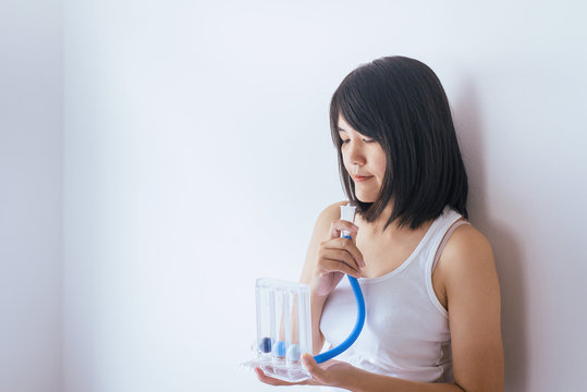Patient woman using incentivespirometer or three balls for stimulate lung