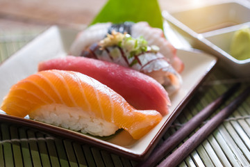 Sushi salmon & tuna sushi shrimp and wasabi on the white plate.selective focus
