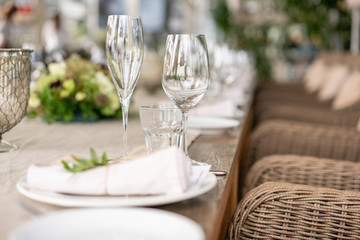 Wedding Banquet or gala dinner. The chairs and table for guests, served with cutlery and crockery. Covered with a linen tablecloth runner. party on terrace