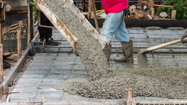 pouring concrete to the ground in construction site