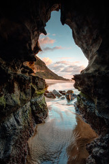 Fototapeta na wymiar Nature's window - sunrise beach cave
