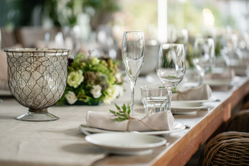 Wedding Banquet or gala dinner. The chairs and table for guests, served with cutlery and crockery. Covered with a linen tablecloth runner. party on terrace