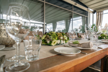 Wedding Banquet or gala dinner. The chairs and table for guests, served with cutlery and crockery. Covered with a linen tablecloth runner. party on terrace