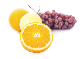 Oranges and grapes on a white background.