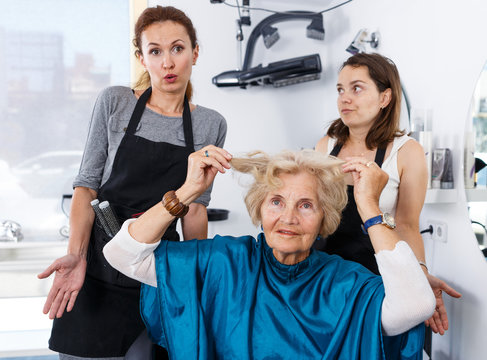 Shocked elderly female client at barbershop