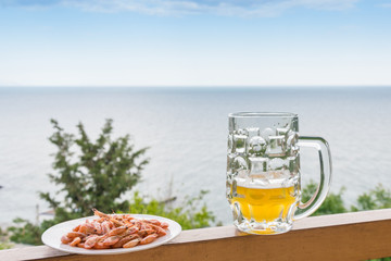 A glass of beer and shrimp.