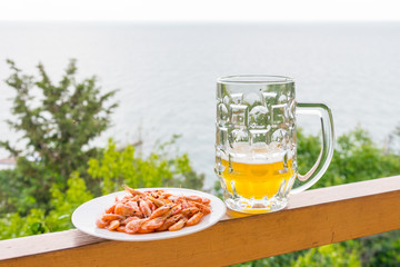A glass of beer and shrimp.