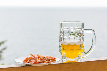 A glass of beer and shrimp.