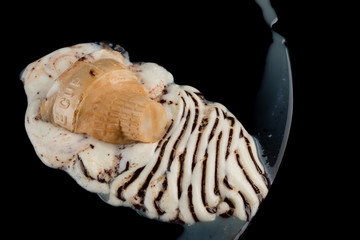 top view ice cream cone melting completely on black background