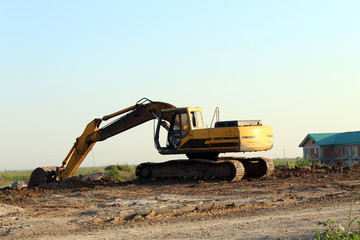 Fototapeta na wymiar Yellow excavator excavating