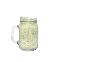 Energy smoothie in a mason jar with white background.