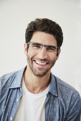 Obraz premium Handsome guy in glasses smiling, portrait