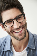 Smiling guy in glasses, looking away