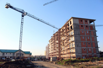 Fototapeta premium Large construction site including several cranes working on a building complex