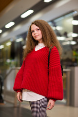 beautiful girl with lush hair standing indoors 