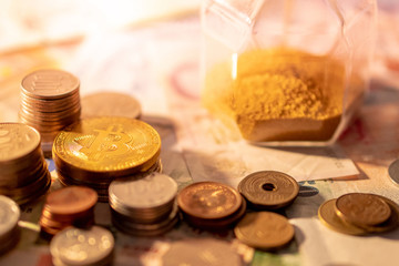 Various of international money coins and bitcoin with hourglass on banknote. Time investment with currency exchange. Worldwide cryptocurrency and digital payment concept