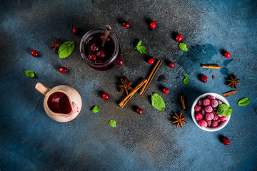 Traditional Thanksgiving Christmas food, homemade cranberry sauce, with mint and fresh berries, dark blue table, with  fir tree and saucer, copy space for text