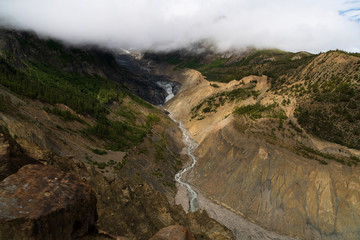 Fototapeta na wymiar The water flowing off Gangapurna glacier creates a gorge in the moraine 