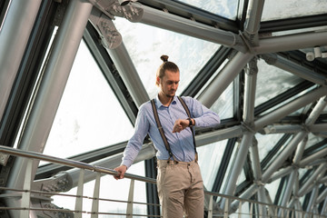 man stands in a bright corridor 