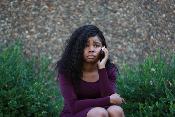 Depressed black female speaking on phone