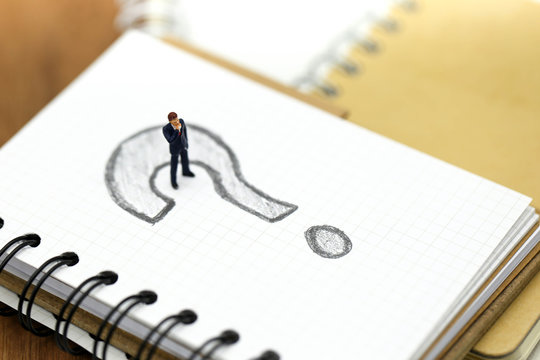 Miniature people : Businessman with THE QUESTION MARK using for concept Punctuation Day