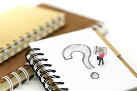 Miniature people : Businessman with THE QUESTION MARK using for concept Punctuation Day