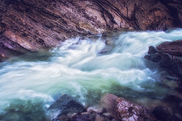 Long exposure photo of mountain river flowing through rocks