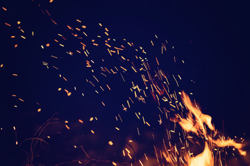 Night fire with sparks. Toned photo with copyspace - Powered by Adobe
