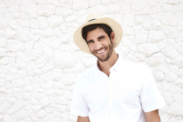 Smiling guy in hat and white shirt